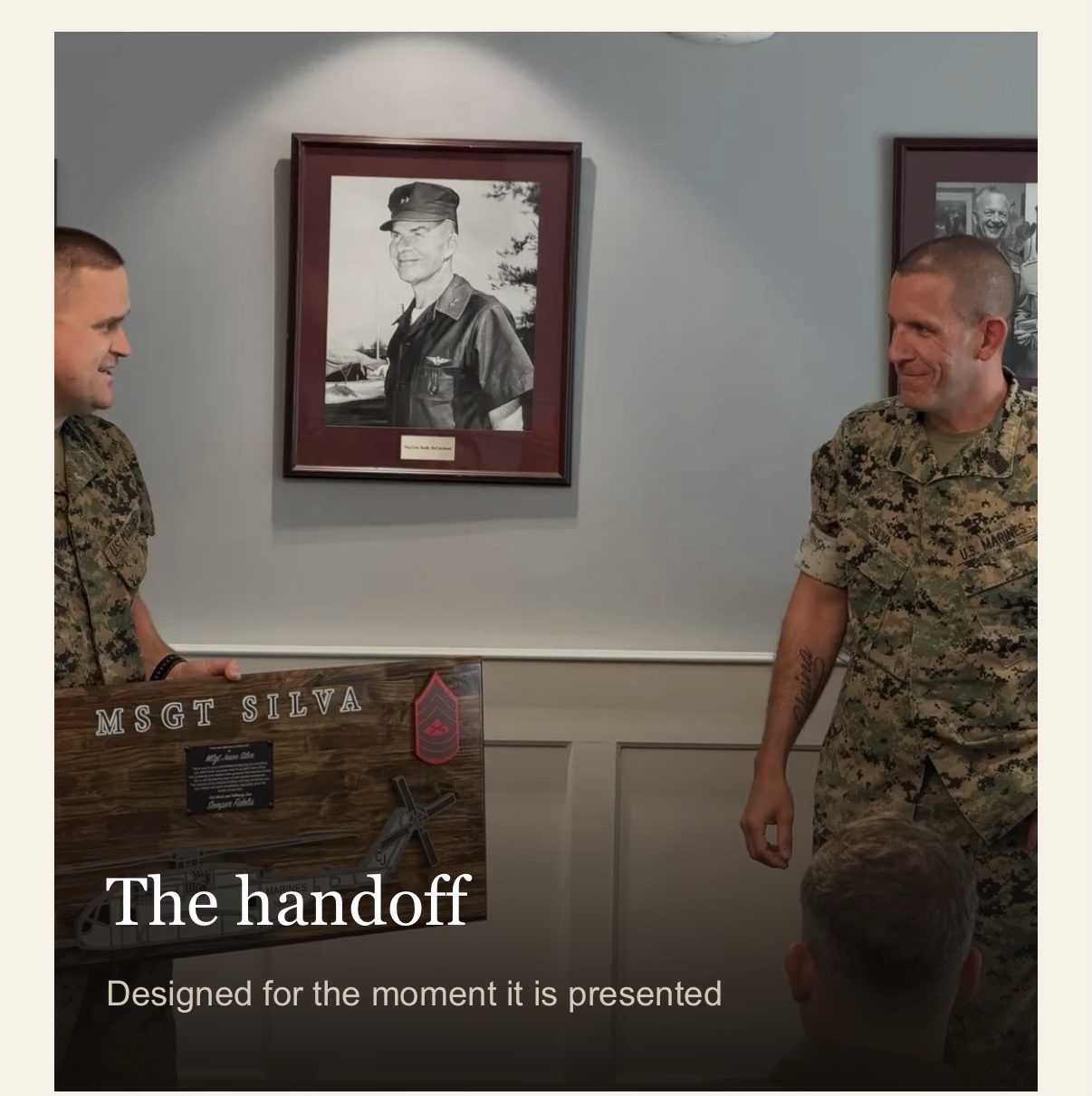 The Handoff feature image showing Marines sharing a plaque presentation